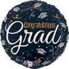 Round balloon with congratulations grad text, dark background, gold and white confetti, graduation caps, stars