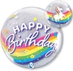 A bubble balloon that has a rainbow stripe on it and unicorns on the back with happy birthday written on the front