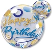 A balloon that has blue and gold dots and circles all over and it says happy birthday in blue and gold lettering