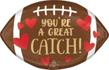 Football shaped Valentine balloon with brown design white laces red hearts and Youre a Great Catch message