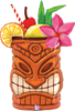 Colorful tiki mug with carved wooden face, orange slice, cherry, striped straw, green leaves, lemon wedge, and pink flower on top